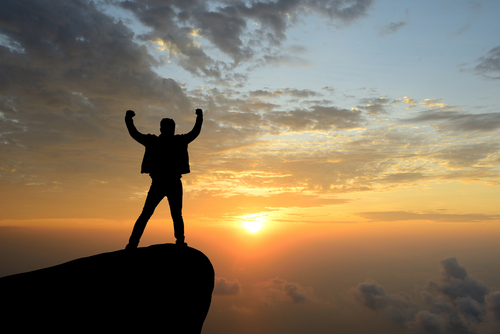 Man on Mountain Celebrating